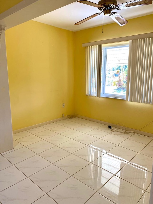 unfurnished room with ceiling fan and light tile patterned floors