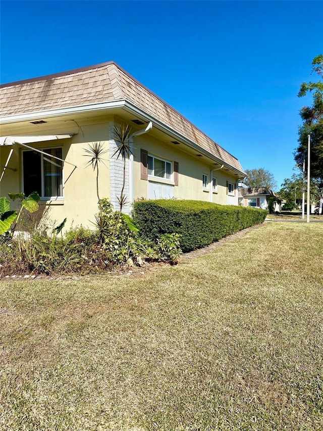 view of property exterior with a lawn