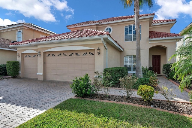 mediterranean / spanish-style home featuring a garage