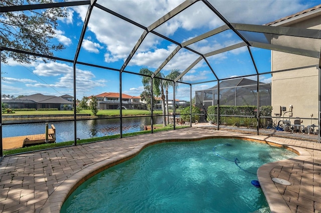 view of swimming pool featuring a lanai, a patio area, and a water view