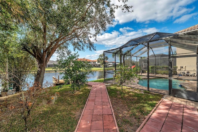 view of yard featuring a lanai and a water view