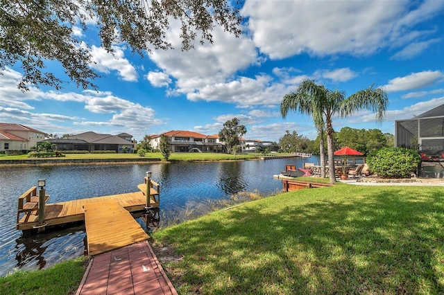 view of dock featuring a yard and a water view