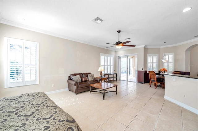 tiled bedroom with ceiling fan and crown molding