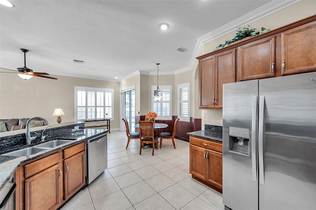 kitchen with stainless steel appliances, a wealth of natural light, crown molding, and sink