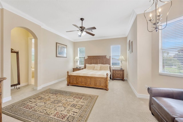 carpeted bedroom with ceiling fan with notable chandelier and ornamental molding