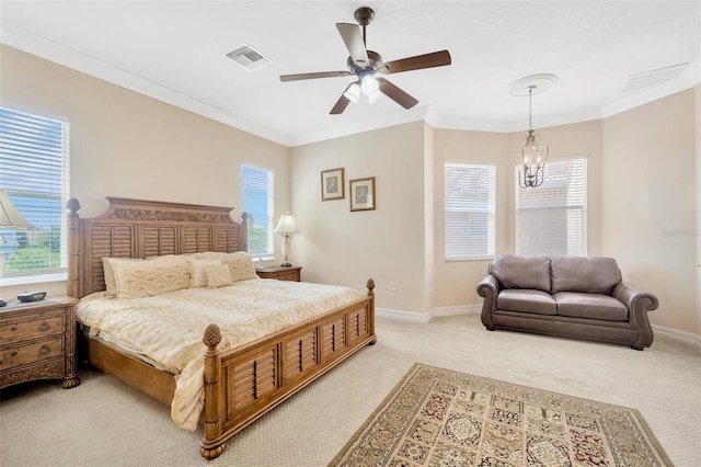 bedroom featuring multiple windows, ceiling fan with notable chandelier, and ornamental molding