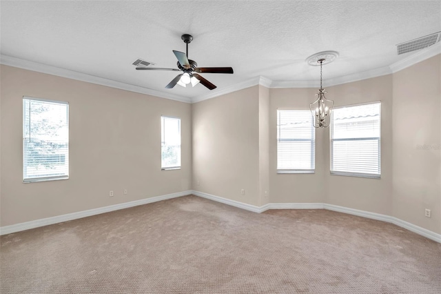 spare room with a wealth of natural light, crown molding, and light colored carpet