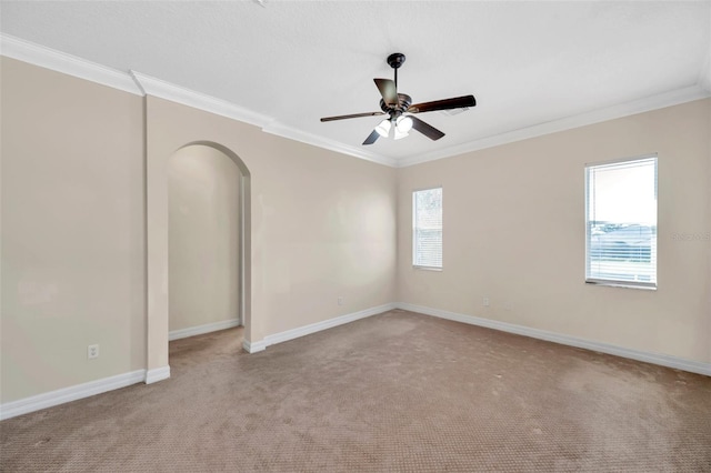 unfurnished room with light colored carpet, plenty of natural light, and crown molding