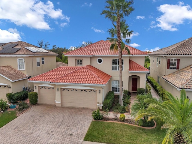 mediterranean / spanish-style home with a garage