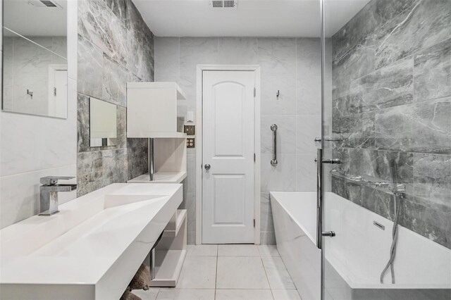 bathroom with tile patterned flooring, vanity, tile walls, and plus walk in shower