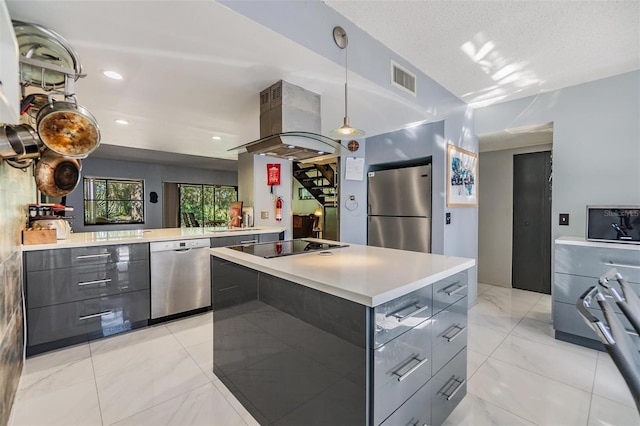 kitchen featuring appliances with stainless steel finishes, island range hood, gray cabinets, and a spacious island