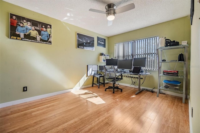 office featuring hardwood / wood-style floors, a textured ceiling, and ceiling fan