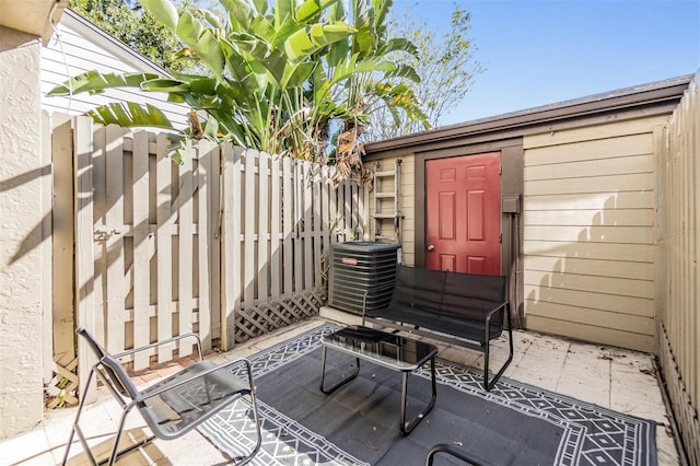 view of patio / terrace with central AC and a storage shed