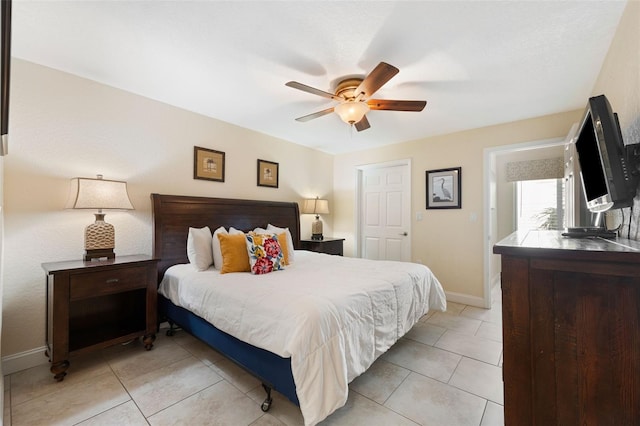 tiled bedroom featuring ceiling fan