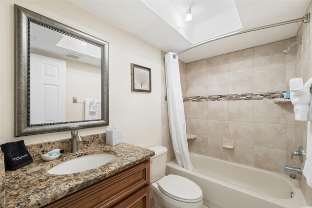 full bathroom with shower / bath combination with curtain, toilet, and vanity