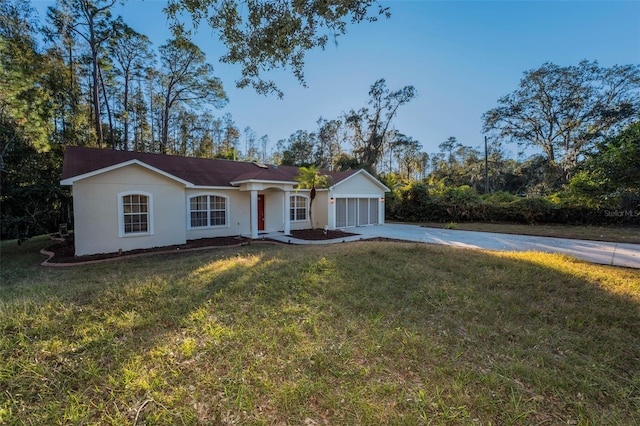 single story home featuring a front yard and a garage