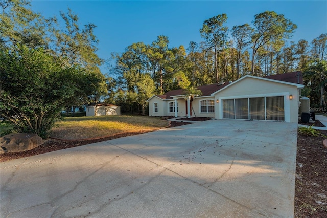 ranch-style house featuring a front lawn and a storage shed