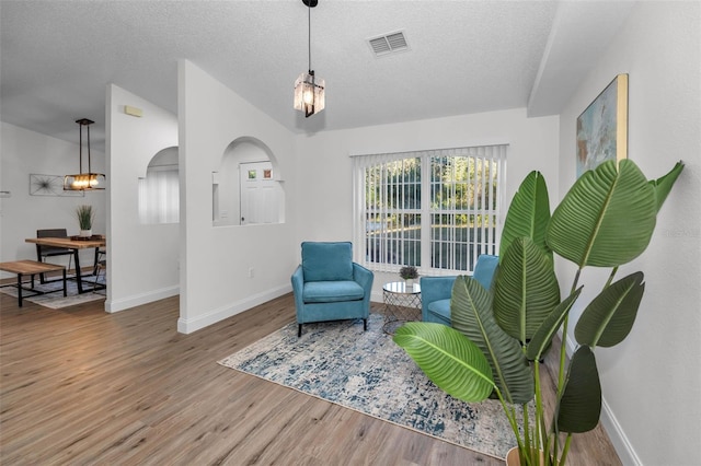 sitting room featuring hardwood / wood-style floors and a textured ceiling