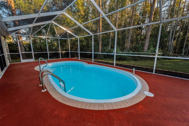 view of pool with a patio and a lanai