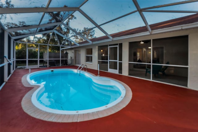 view of pool featuring a patio and glass enclosure