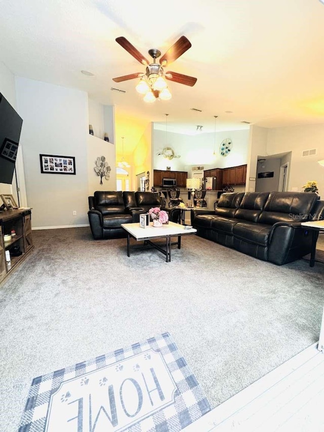 carpeted living room featuring ceiling fan