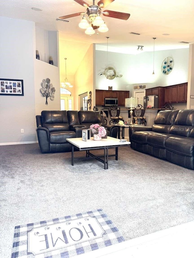 carpeted living room with high vaulted ceiling and ceiling fan