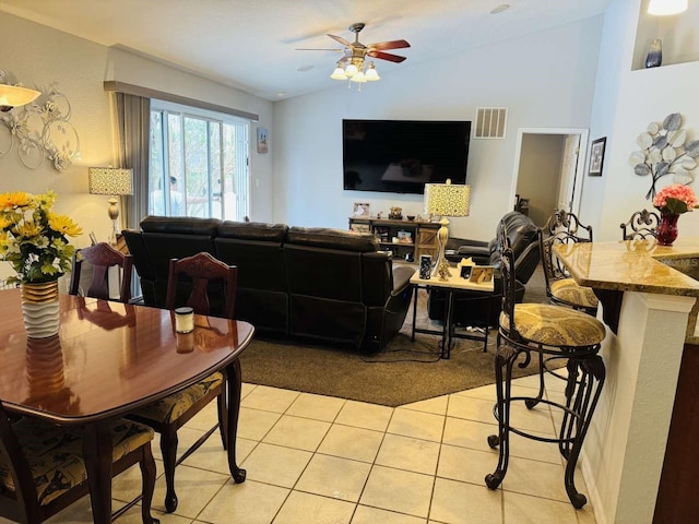 tiled living room featuring ceiling fan and lofted ceiling