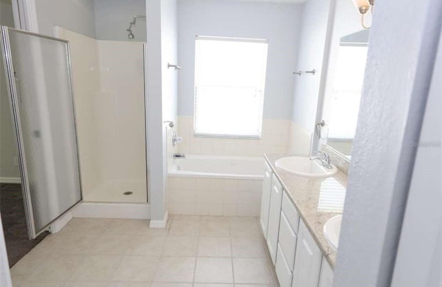 bathroom featuring tile patterned floors, vanity, and plus walk in shower