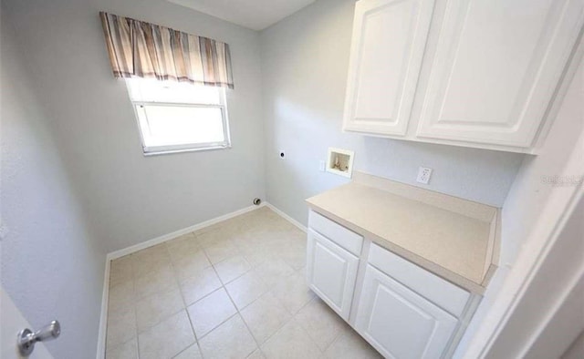 laundry room featuring electric dryer hookup, cabinets, and washer hookup