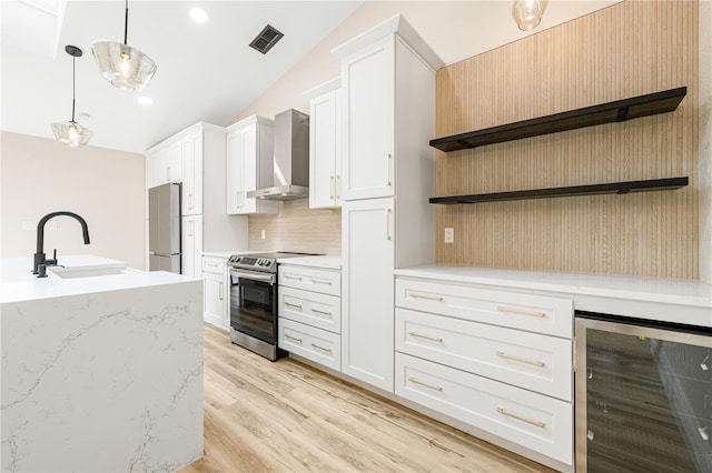 kitchen featuring wall chimney exhaust hood, white cabinets, beverage cooler, and appliances with stainless steel finishes