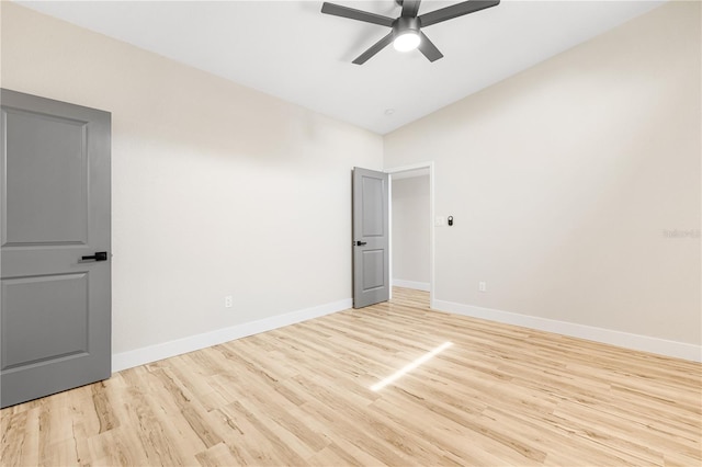 unfurnished room featuring ceiling fan, light hardwood / wood-style flooring, and vaulted ceiling