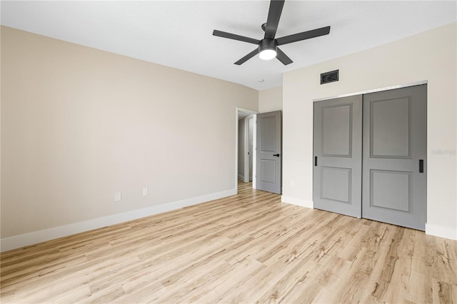 unfurnished bedroom with ceiling fan, light hardwood / wood-style floors, and a closet