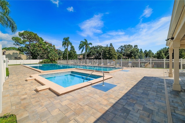 view of pool featuring a community hot tub and a patio