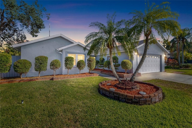 view of front facade featuring a garage and a yard