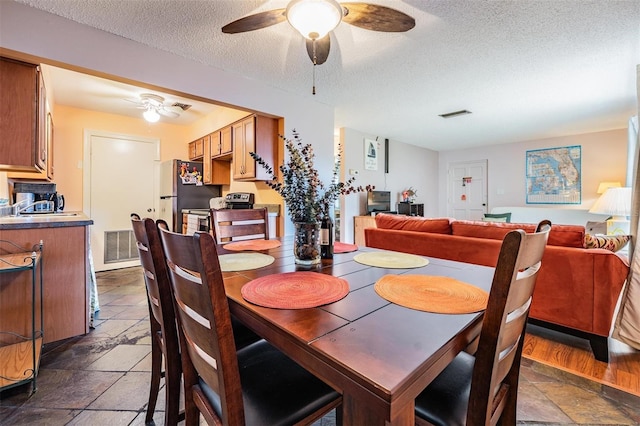 dining space with a textured ceiling