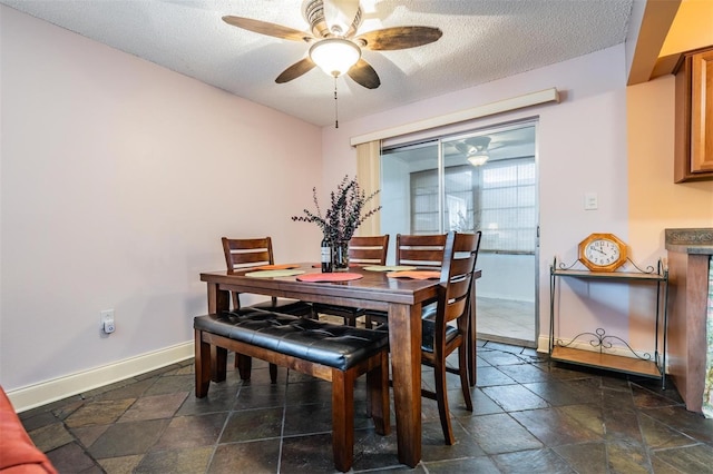 dining space with ceiling fan and a textured ceiling