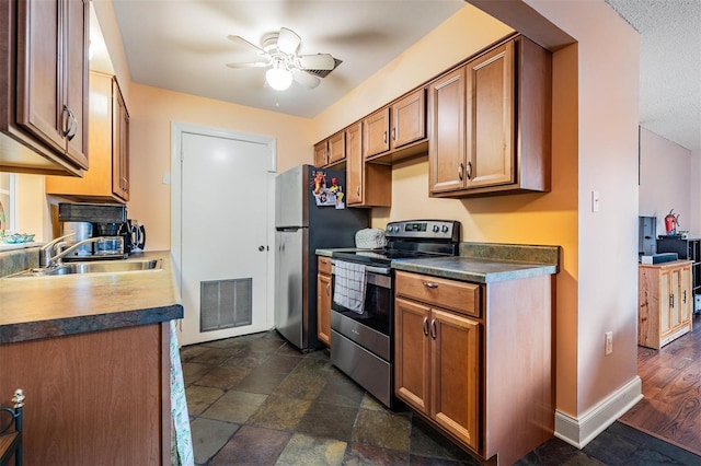 kitchen with ceiling fan, dark hardwood / wood-style floors, sink, and stainless steel appliances