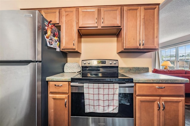 kitchen with stainless steel appliances and a textured ceiling