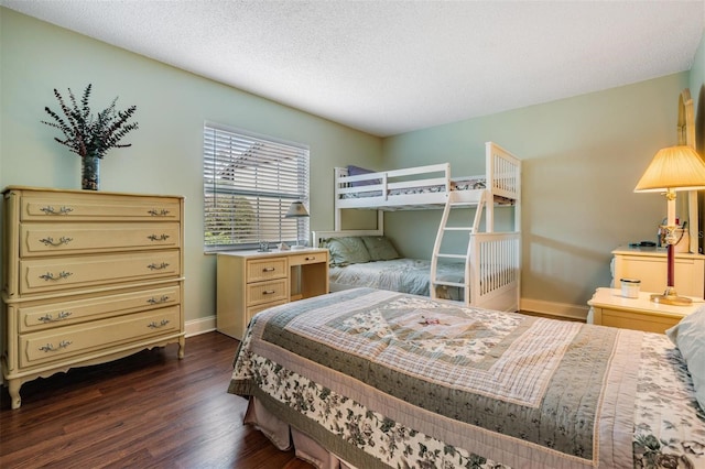 bedroom featuring a textured ceiling and dark wood-type flooring