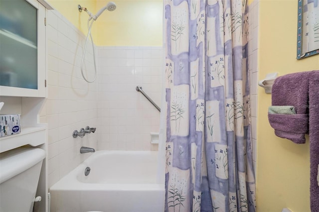 bathroom with shower / bath combo with shower curtain and toilet