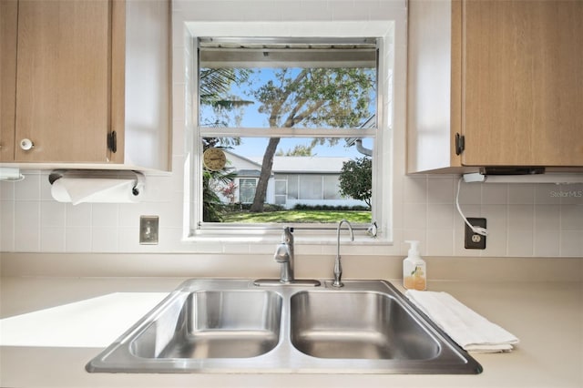 kitchen featuring tasteful backsplash and sink