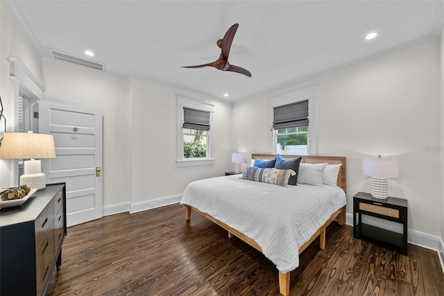 bedroom with ceiling fan, crown molding, and dark wood-type flooring