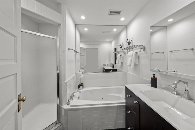 bathroom featuring vanity and independent shower and bath