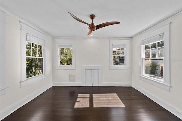 unfurnished room featuring ceiling fan and dark hardwood / wood-style flooring