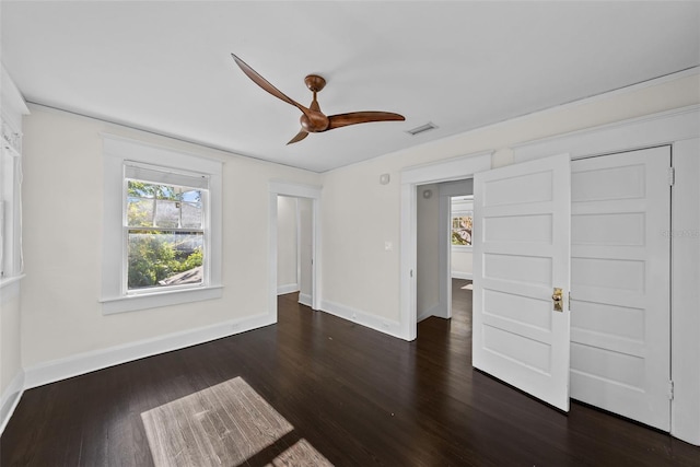 spare room featuring ceiling fan and dark hardwood / wood-style floors