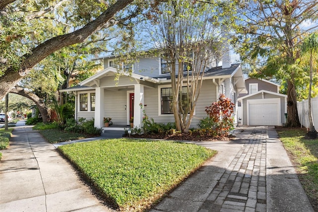 front of property with a garage and an outdoor structure