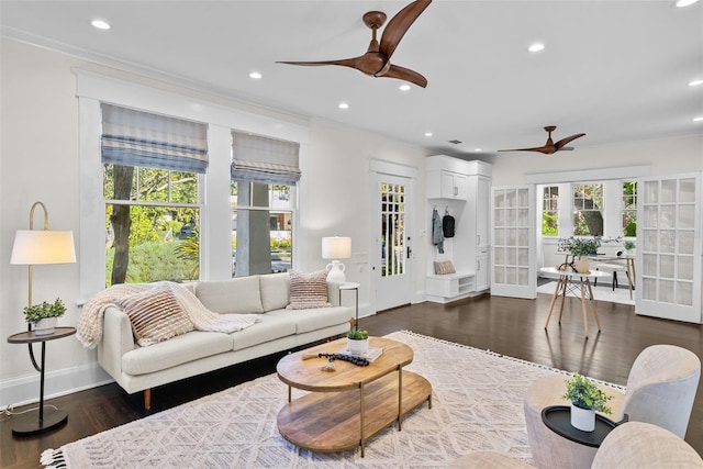 living room with ceiling fan, french doors, dark wood-type flooring, and ornamental molding