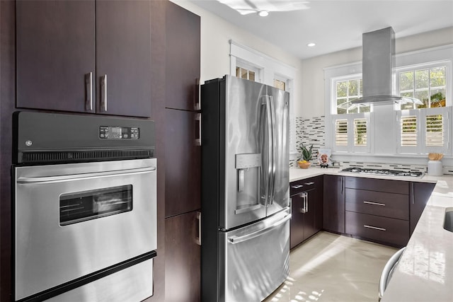 kitchen with dark brown cabinets, island range hood, and stainless steel appliances