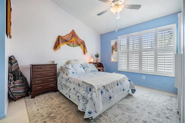 bedroom with ceiling fan, light carpet, and a textured ceiling