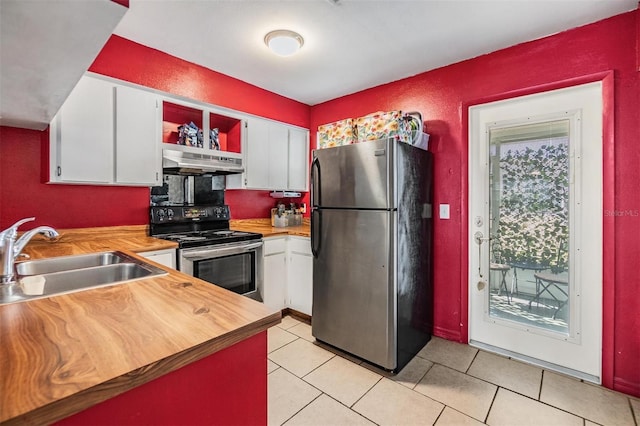 kitchen featuring sink, white cabinets, light tile patterned flooring, and appliances with stainless steel finishes